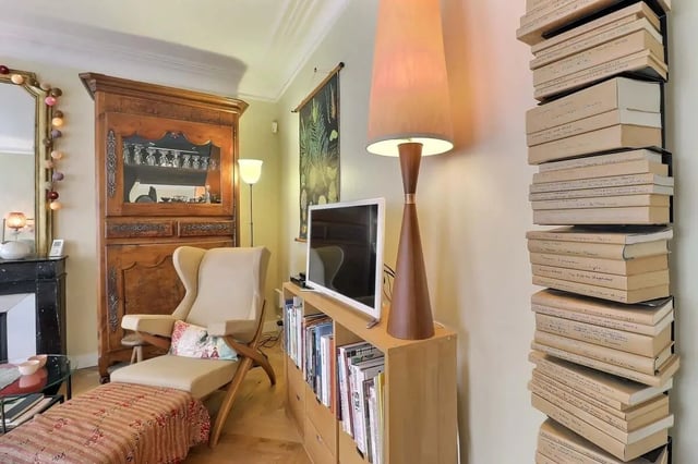 Bookshelf armchair television lamp and cabinet living room at Apartment in Rue Clauzel, 75009 Paris, France in Paris Student Accommodation