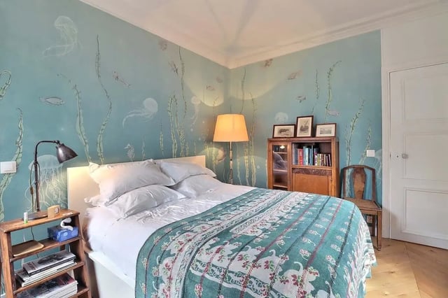 Bed with ocean mural bookshelf chair bedroom at Apartment in Rue Clauzel, 75009 Paris, France in Paris Student Accommodation