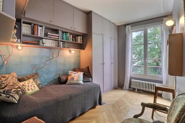 Daybed bookshelves wardrobe with window view Bedroom at Apartment in Rue Clauzel, 75009 Paris, France in Paris Student Accommodation