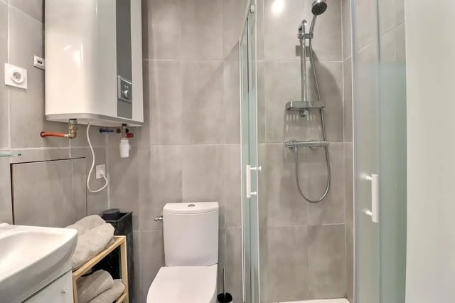 Sink toilet shower heater shelving towels bathroom at Studio in Av. Félix Faure, 75015 Paris, France in Paris Student Accommodation