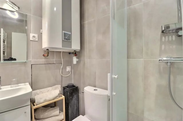 Toilet sink water heater shower stall bathroom at Studio in Av. Félix Faure, 75015 Paris, France in Paris Student Accommodation
