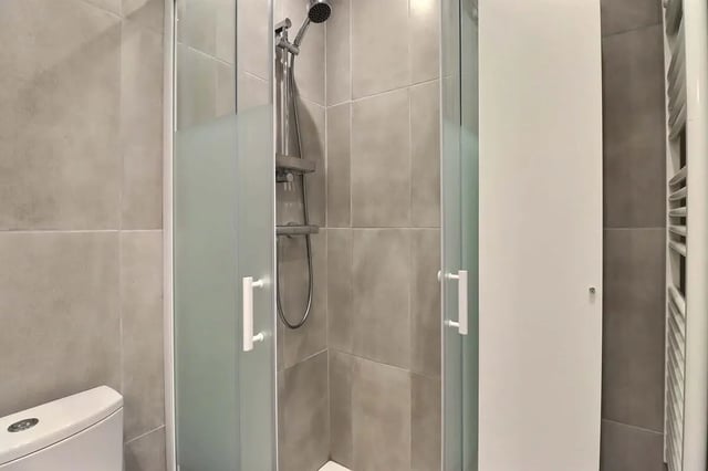 Shower cubicle with toilet and towel rail Bathroom at Studio in Av. Félix Faure, 75015 Paris, France in Paris Student Accommodation