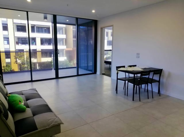 Sofa and dining table with chairs Living room at Belong Eastgardens in Sydney Student Accommodation