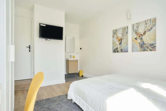 Bed television deer art and bathroom bedroom at Room in 121 Rue Haxo, 75019 Paris, France in Paris Student Accommodation