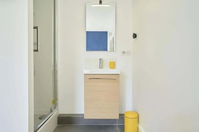 Shower sink mirror and yellow bin bathroom at Room in 121 Rue Haxo, 75019 Paris, France in Paris Student Accommodation