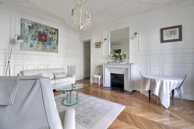 White sofa glass table fireplace and dining area living room at Apartment in Rue Villaret de Joyeuse, 75017 Paris, France in Paris Student Accommodation