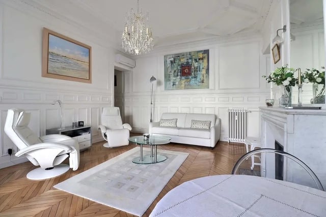 White sofa two recliners glass coffee table living room at Apartment in Rue Villaret de Joyeuse, 75017 Paris, France in Paris Student Accommodation