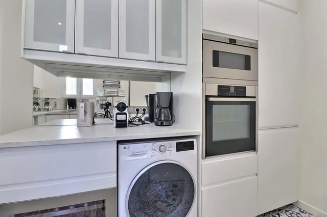 Washer coffee maker oven and cabinets kitchen at Apartment in Rue Villaret de Joyeuse, 75017 Paris, France in Paris Student Accommodation