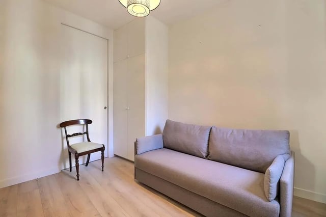 Sofa chair wardrobe and door living room at Apartment in Rue Villaret de Joyeuse, 75017 Paris, France in Paris Student Accommodation