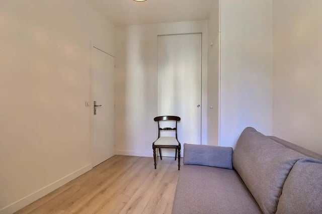 Sofa chair and doors living room at Apartment in Rue Villaret de Joyeuse, 75017 Paris, France in Paris Student Accommodation