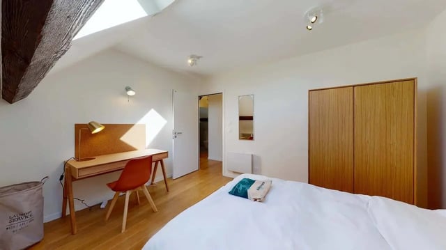 Desk chair laundry basket wooden wardrobe bedroom at Lucette - Private Room (10) in Pantin Student Accommodation