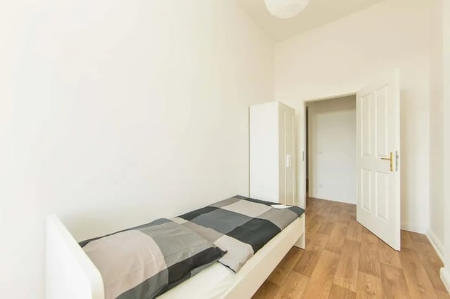 Bed wardrobe and open door bedroom at Hohenzollerndamm 53.6 in Berlin Student Accommodation