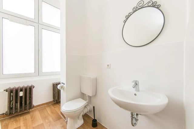 Toilet sink mirror wooden floor bathroom at Hohenzollerndamm 53.6 in Berlin Student Accommodation