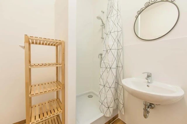 Wooden shelves sink shower and mirror Bathroom at Hohenzollerndamm 53.6 in Berlin Student Accommodation