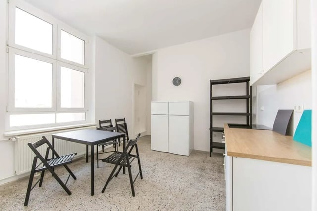 Dining table chairs refrigerator shelf kitchen counter kitchen at Hohenzollerndamm 53.6 in Berlin Student Accommodation