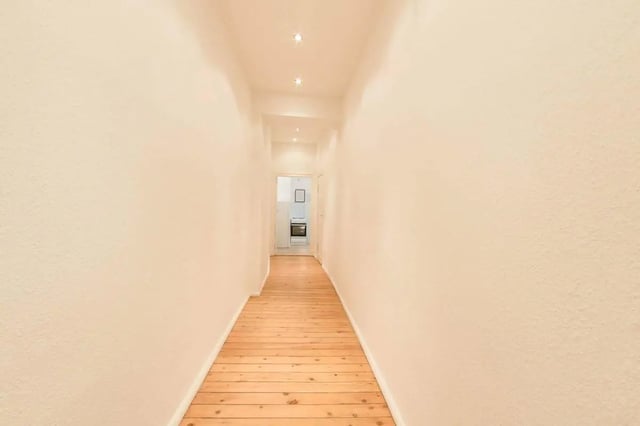Hallway with wood floor leading to kitchen area at Room in Detmolder Str., 10713 Berlin, Germany in Berlin Student Accommodation