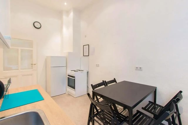 Fridge oven table chairs clock kitchen at Room in Detmolder Str., 10713 Berlin, Germany in Berlin Student Accommodation