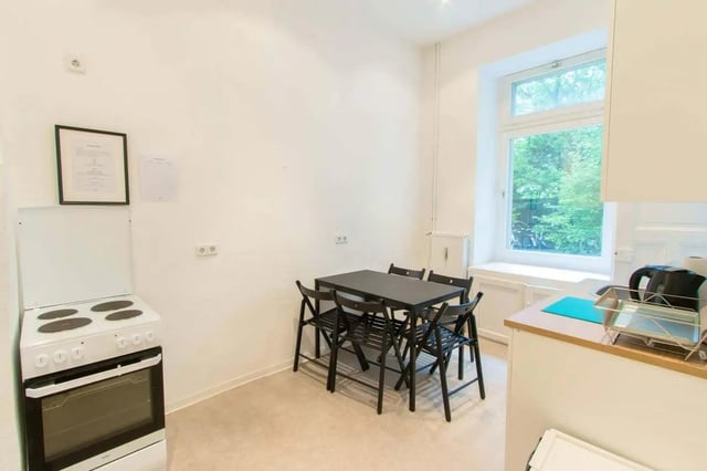 Stove dining table chairs window kitchen at Room in Detmolder Str., 10713 Berlin, Germany in Berlin Student Accommodation