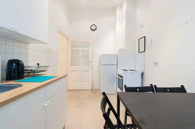 Kitchen with refrigerator oven table and chairs kitchen at Room in Detmolder Str., 10713 Berlin, Germany in Berlin Student Accommodation
