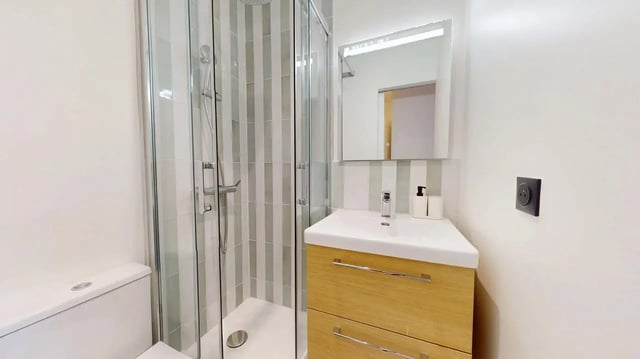Toilet sink shower mirror and tiled walls bathroom at Bovary House - Room S (11) in Paris Student Accommodation