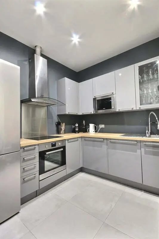 Modern kitchen with gray cabinets oven microwave sink kitchen at Apartment 1 bedroom 41m² in Paris Student Accommodation