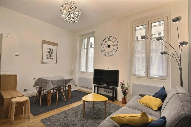 Dining table couch television living room at Apartment 1 bedroom 41m² in Paris Student Accommodation