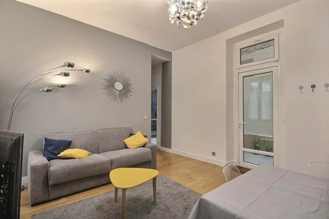 Gray sofa yellow coffee table modern lamp living area at Apartment 1 bedroom 41m² in Paris Student Accommodation