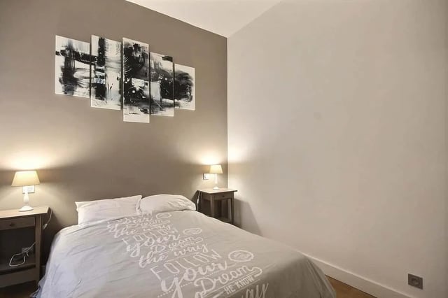 Bed with graphic duvet bedside tables lamps bedroom at Apartment 1 bedroom 41m² in Paris Student Accommodation