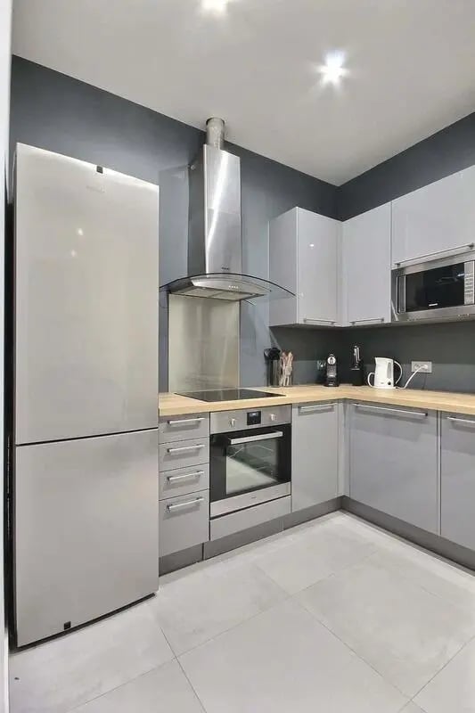 Modern kitchen with stainless steel appliances and grey cabinets kitchen at Apartment 1 bedroom 41m² in Paris Student Accommodation