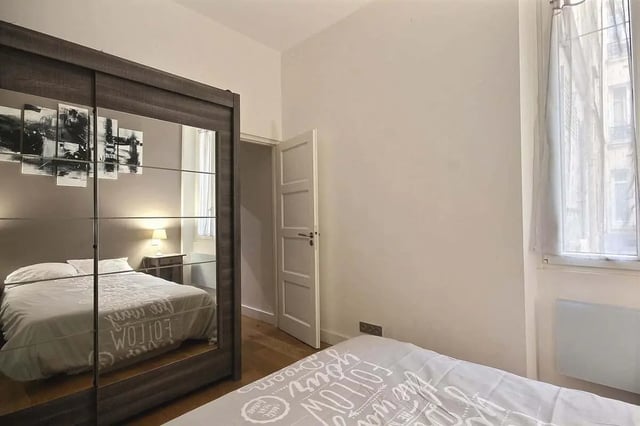 Mirrored wardrobe bed lamp and door bedroom at Apartment 1 bedroom 41m² in Paris Student Accommodation