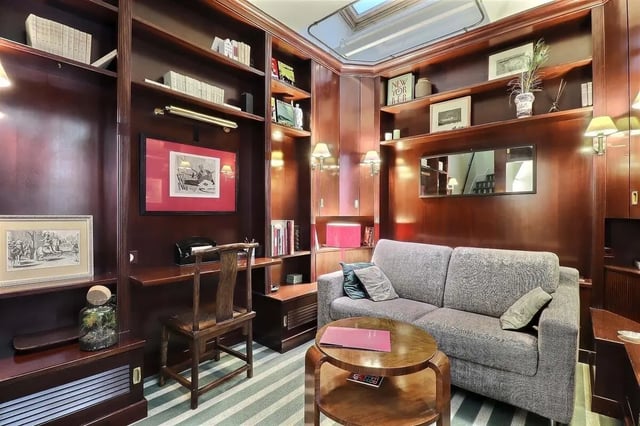 Bookshelves desk chair sofa coffee table living room at Apartment in Rue Saint-Honoré, 75001 Paris, France in Paris Student Accommodation