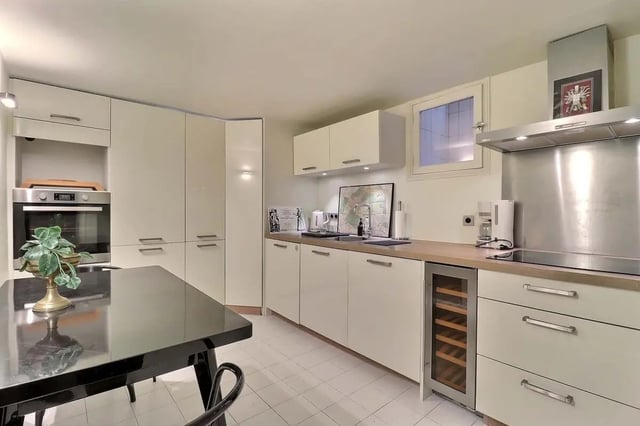 Modern kitchen with oven wine fridge and dining table kitchen at Apartment in Rue Saint-Honoré, 75001 Paris, France in Paris Student Accommodation