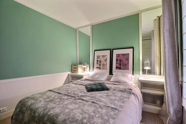 Bed with patterned quilt and framed art Bedroom at Apartment in Rue Saint-Honoré, 75001 Paris, France in Paris Student Accommodation