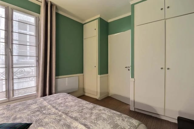 Bed wardrobe and window bedroom interior at Apartment in Rue Saint-Honoré, 75001 Paris, France in Paris Student Accommodation