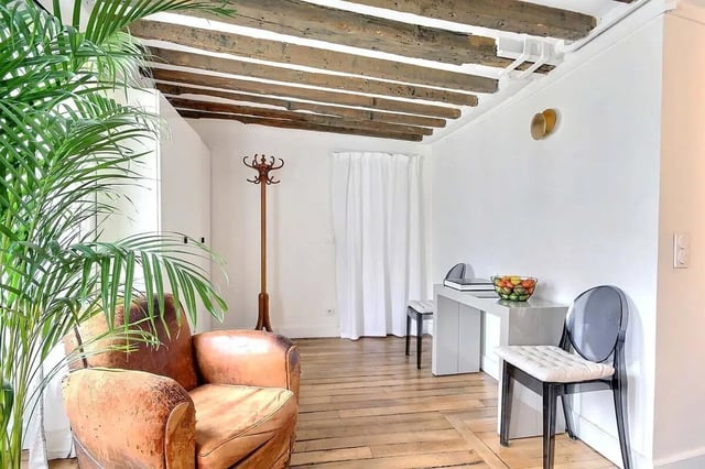 Leather armchair coat rack desk chairs living room at Apartment 1 bedroom 60m² in Paris Student Accommodation