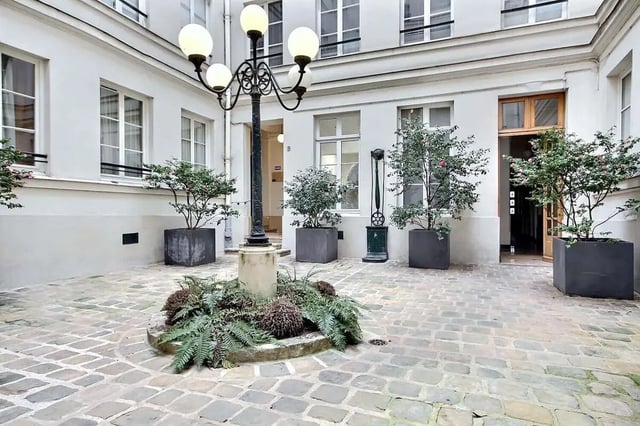 Courtyard with cobblestones plants and lamppost exterior at Apartment 1 bedroom 60m² in Paris Student Accommodation