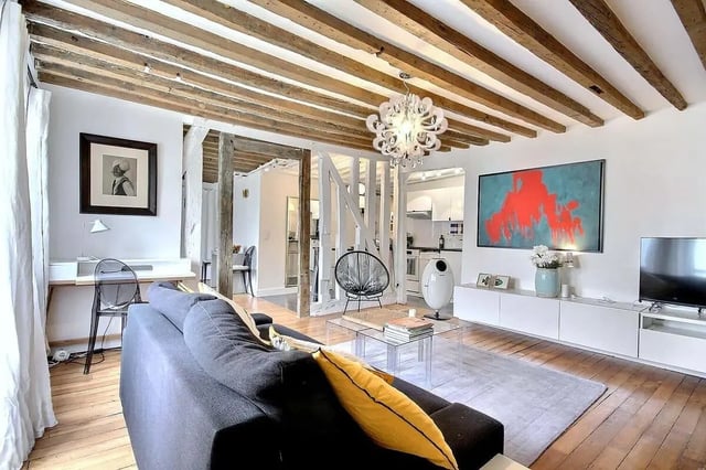 Sofa desk chair artwork and TV living room at Apartment 1 bedroom 60m² in Paris Student Accommodation