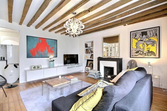 Sofa artwork fireplace and tv living room at Apartment 1 bedroom 60m² in Paris Student Accommodation
