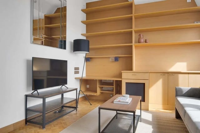 TV shelving unit desk and sofa living room at Rue de Bretagne in Paris Student Accommodation