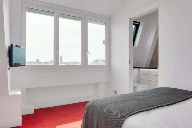 Bed TV window red carpet closet bedroom at Rue de Bretagne in Paris Student Accommodation