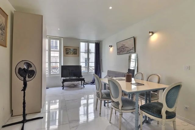 Dining set and sofa in open-plan living area at Apartment in Rue Sedaine, Paris for 37 m² with 1 bedroom in Paris Student Accommodation