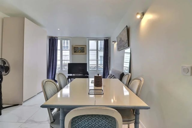 Dining table six chairs television and windows Living room at Apartment in Rue Sedaine, Paris for 37 m² with 1 bedroom in Paris Student Accommodation