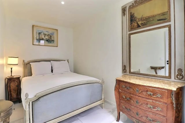Bed with bedside table painting mirror bedroom at Apartment in Rue Sedaine, Paris for 37 m² with 1 bedroom in Paris Student Accommodation