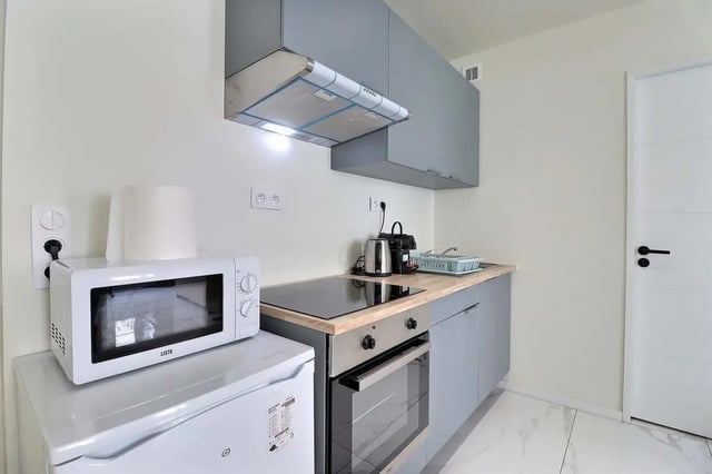 Microwave fridge oven electric hob kitchen cabinets kitchen at Apartment in Rue Sedaine, Paris for 37 m² with 1 bedroom in Paris Student Accommodation