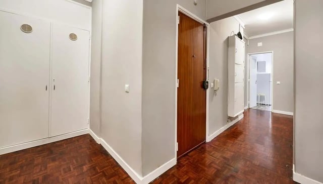 Hallway with white cabinets and wooden floor hallway at Casa Abel II – Room 5 in Lisbon Student Accommodation