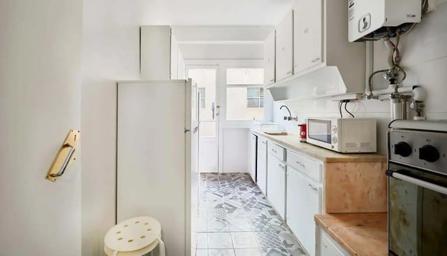 Refrigerator microwave oven stove and cabinets kitchen at Casa Abel II – Room 5 in Lisbon Student Accommodation