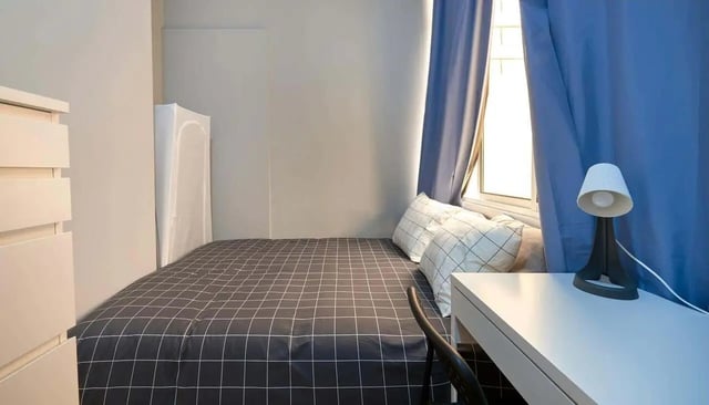 Bed dresser pillows lamp desk bedroom at Casa Elias III – Room 11 in Lisbon Student Accommodation