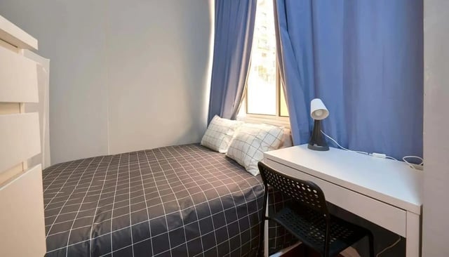 Bed desk lamp and chair bedroom at Casa Elias III – Room 11 in Lisbon Student Accommodation