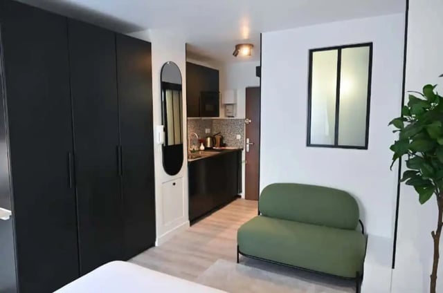 Wardrobe mirror kitchen small sofa living room at Splendide grand studio parking Canal Saint Martin (Paris) in Paris Student Accommodation