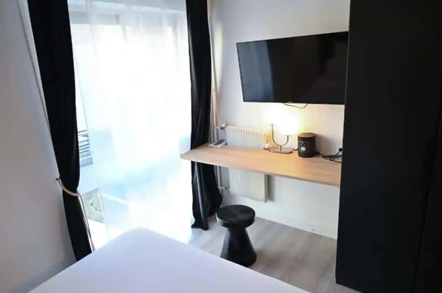 Desk TV lamp stool and wardrobe bedroom at Splendide grand studio parking Canal Saint Martin (Paris) in Paris Student Accommodation